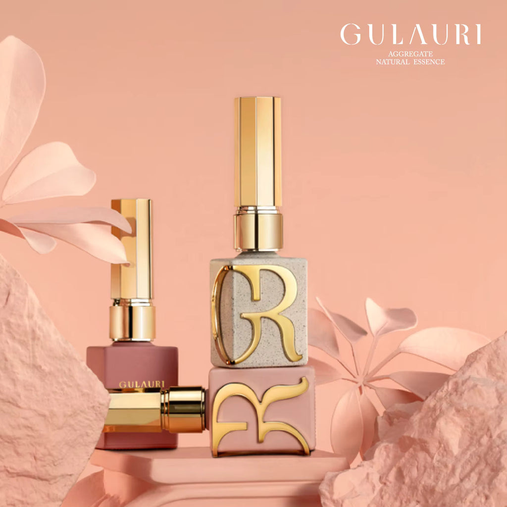 Gulauri perfume bottles with gold caps on a pink background